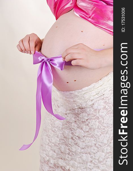 Isolated pregnant woman with a violet bow