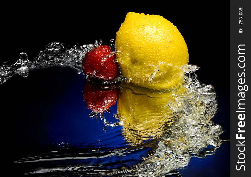 Lemon and strawberry with splashes of water. Lemon and strawberry with splashes of water