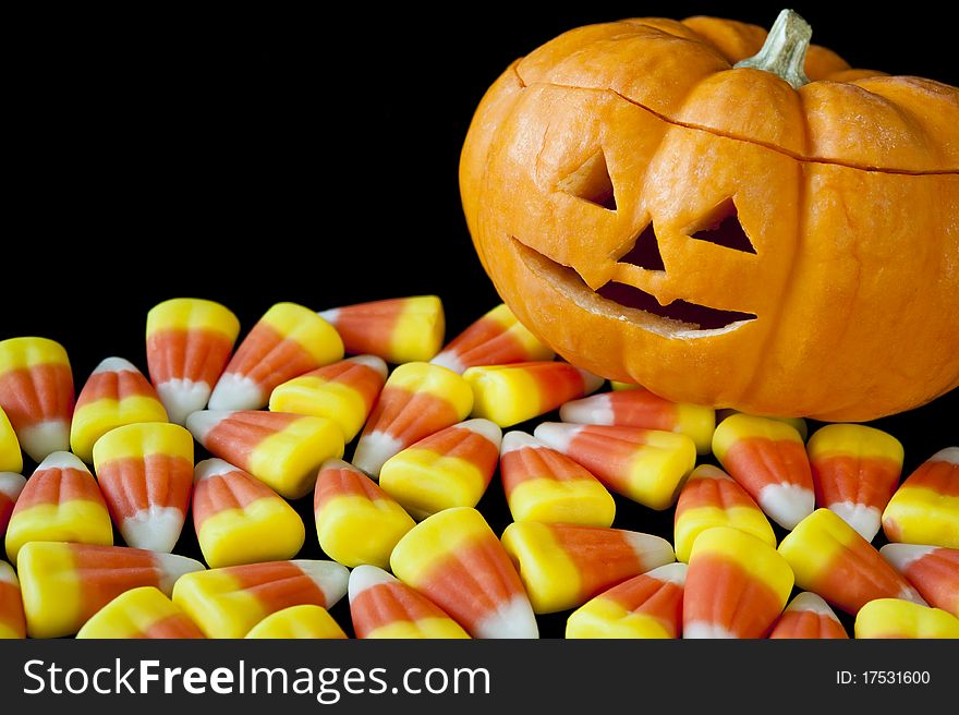 Happy jack-o-lantern with candy corn. Happy jack-o-lantern with candy corn.