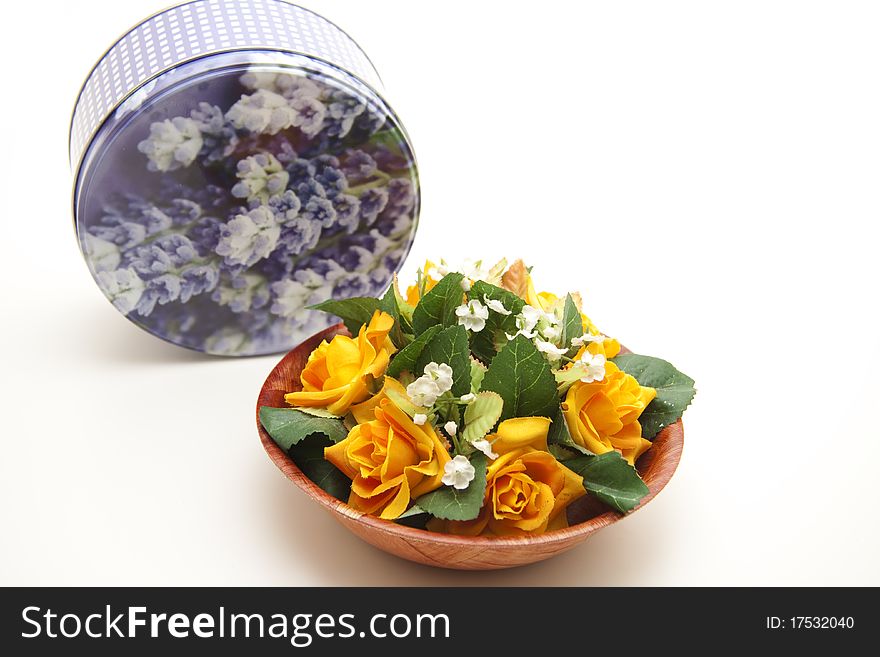 Bunch of flowers in bowl with tin can