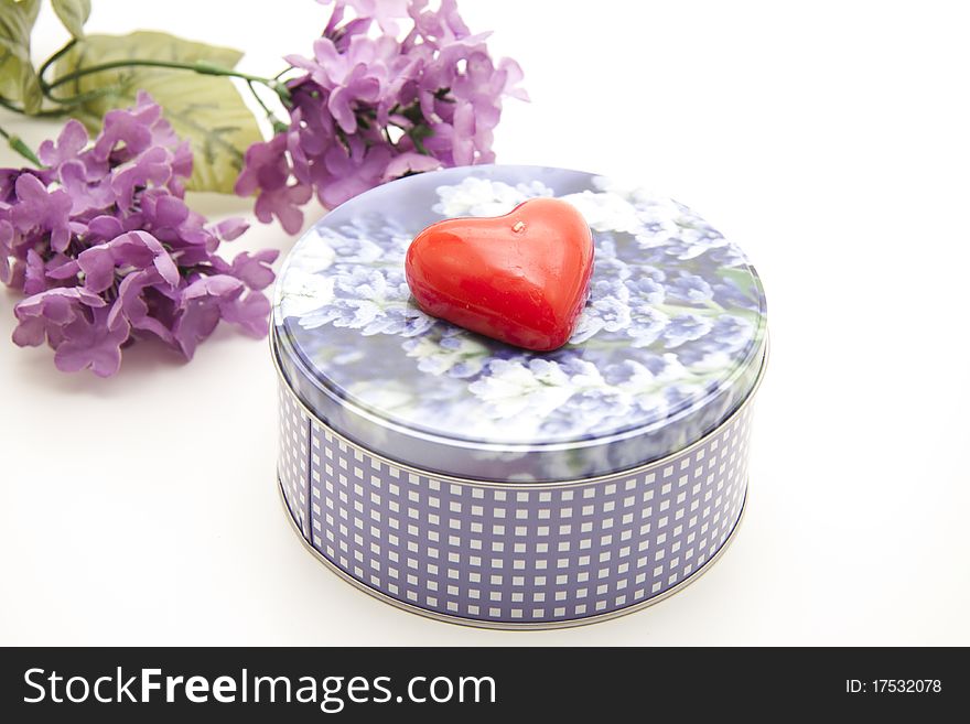 Bunch of flowers with heart on tin can