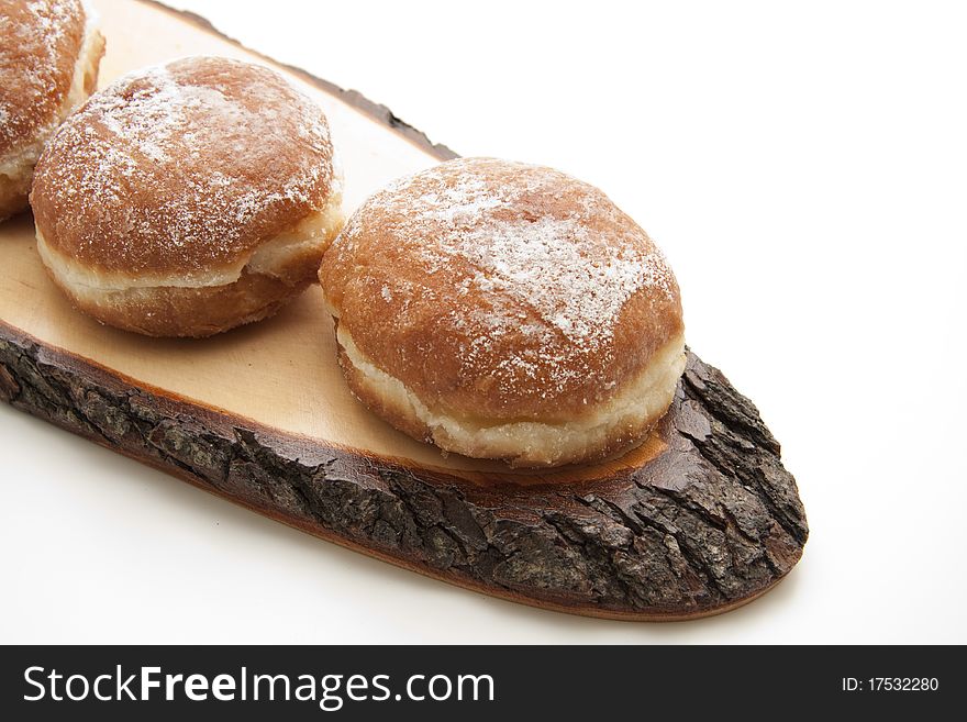 Filled donuts and on wood board with bark. Filled donuts and on wood board with bark