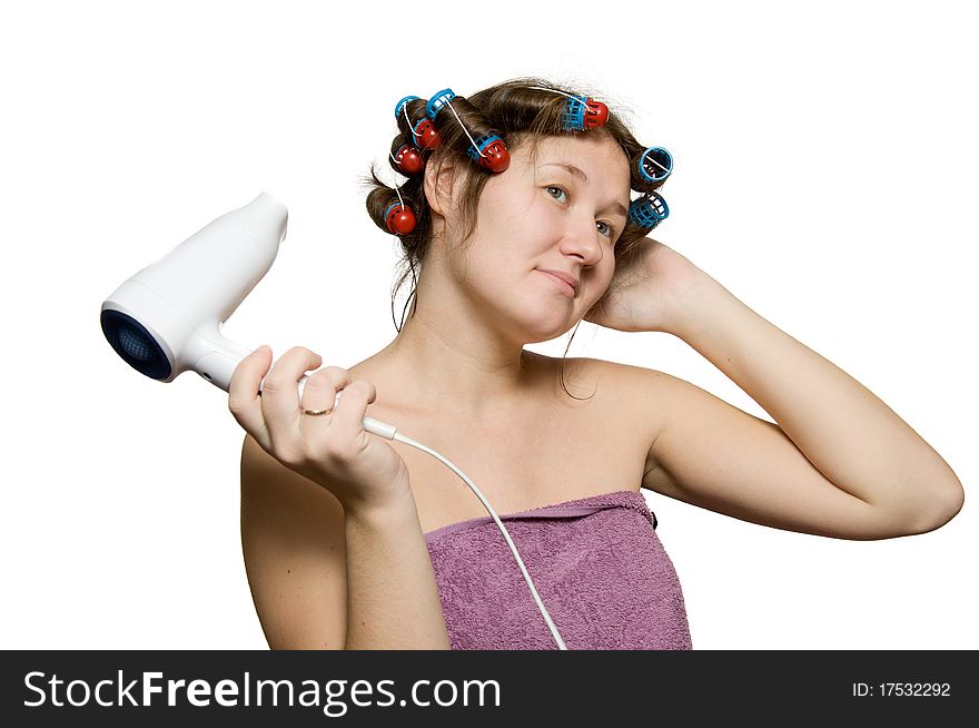Young woman is doing hairstyle by dryer and curlers. Young woman is doing hairstyle by dryer and curlers