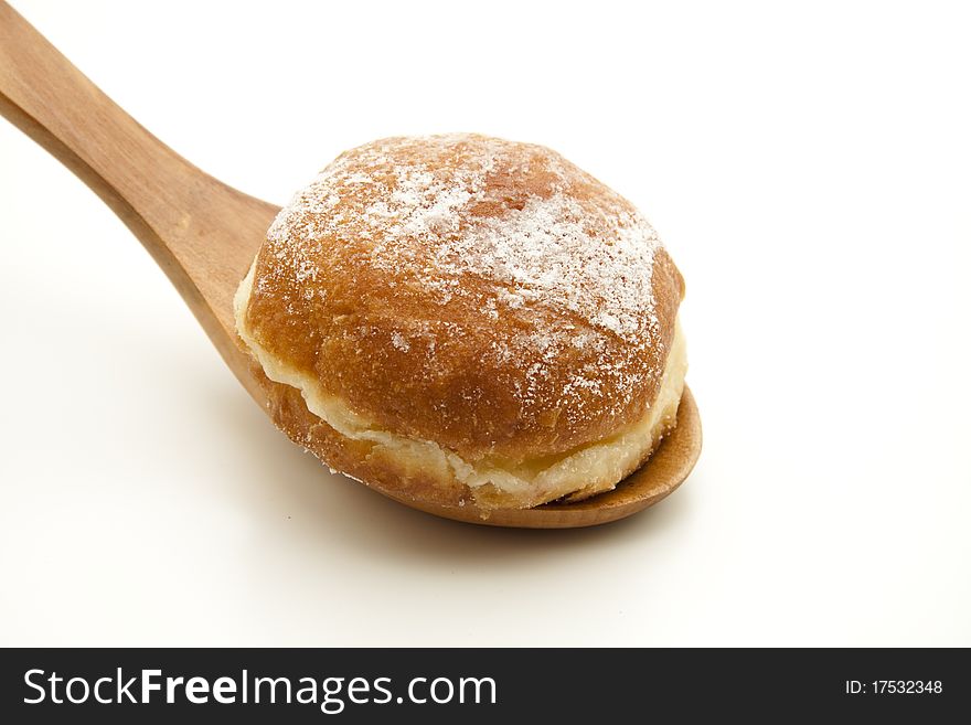 Donut with icing sugar onto wooden spoons. Donut with icing sugar onto wooden spoons