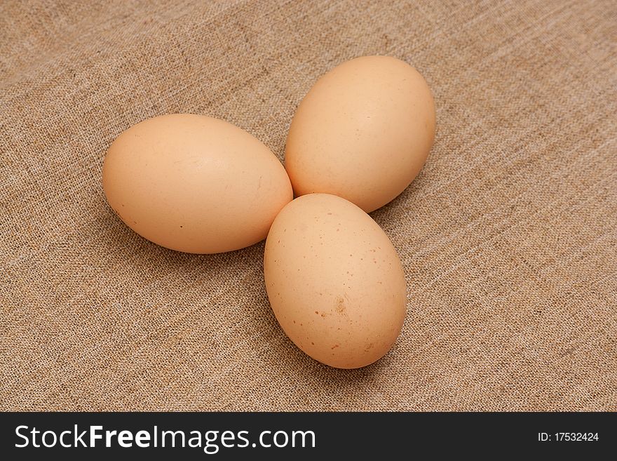 Chicken eggs on brown sacking