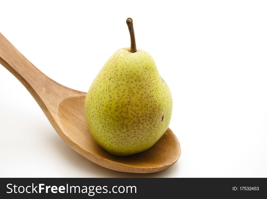 Pear onto wooden spoons onto white background