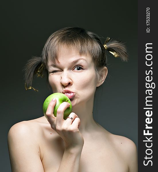 Girl with apple on a dark background