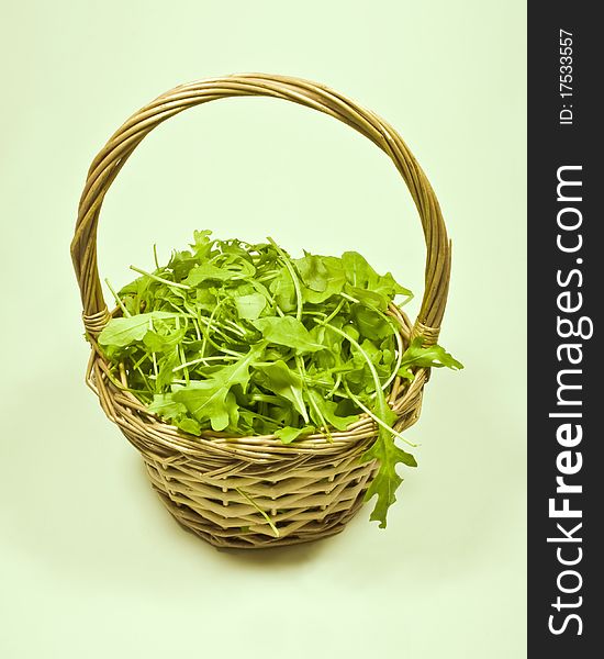 A close up of a wicker basket containg rocket salad. A close up of a wicker basket containg rocket salad