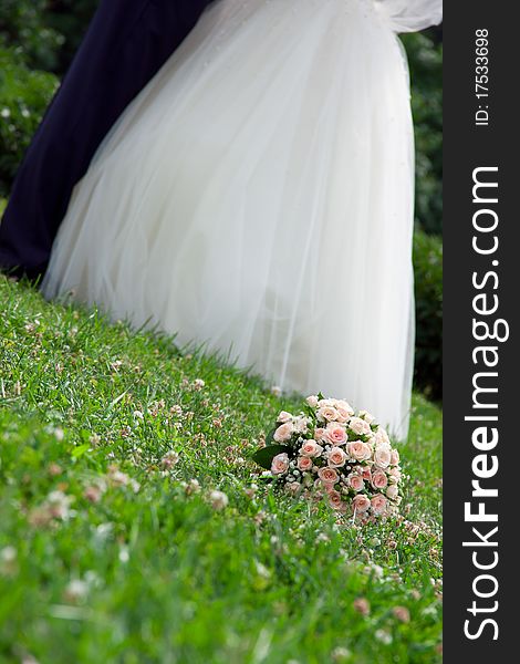 Bridal bouquet lies on the grass