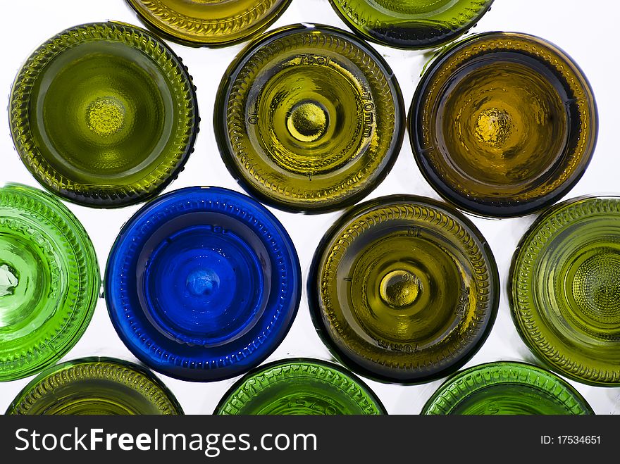 There are many varicoloured bottles on a white background