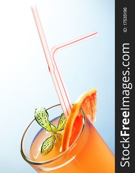 Grapefruit juice on a blue background