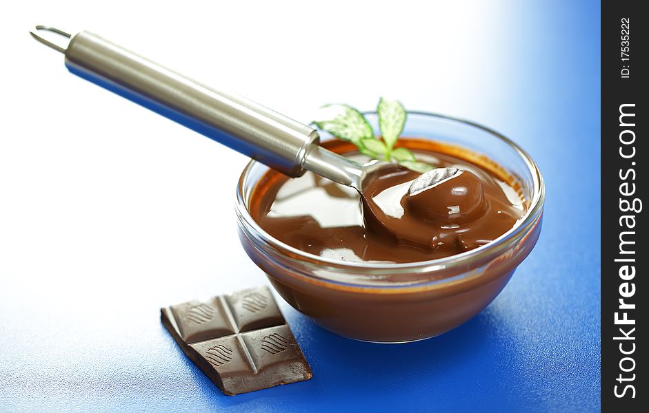 Hot chocolate in a transparent dish with a spoon