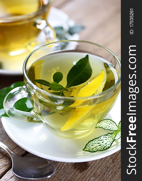 Green tea in a transparent cup with leaf