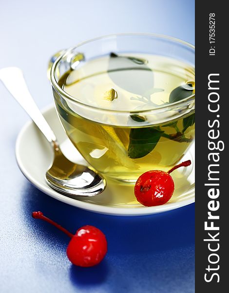 Green tea in a transparent cup with leaf