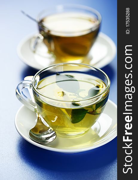 Green tea in a transparent cup with leaf