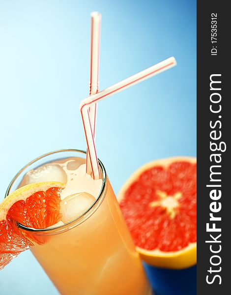 Grapefruit juice on a blue background