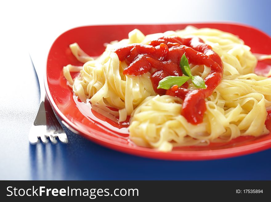 Spaghetti in a red bowl