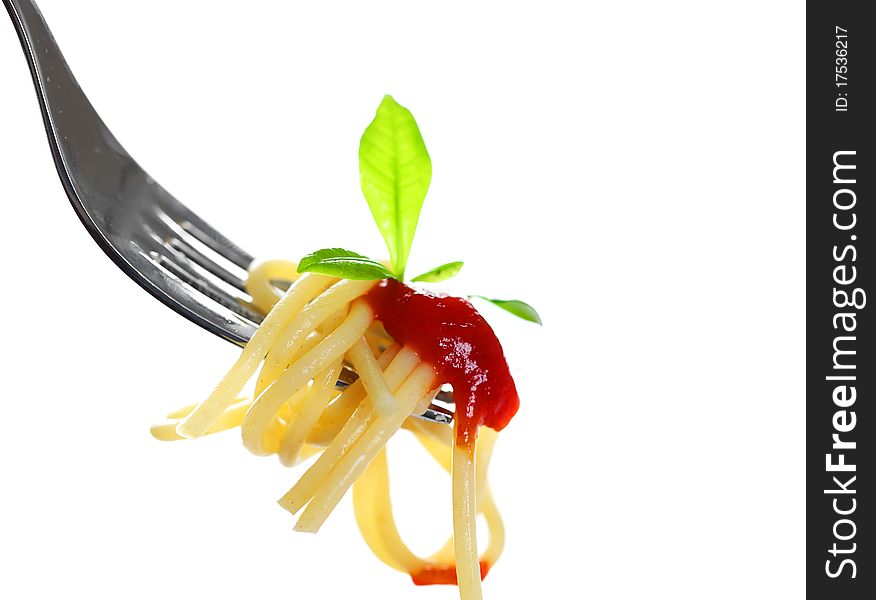 Spaghetti on a fork with a leaf on a white background