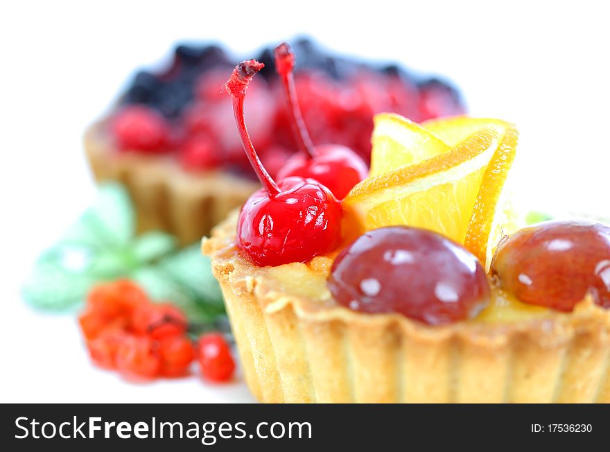 Cupcake with jelly and fruits over white