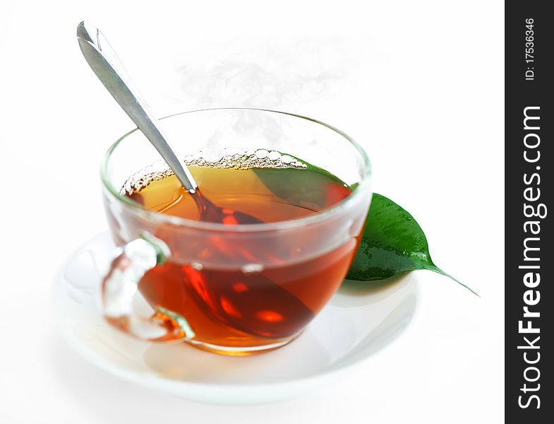 Tea in a transparent cup with leaf