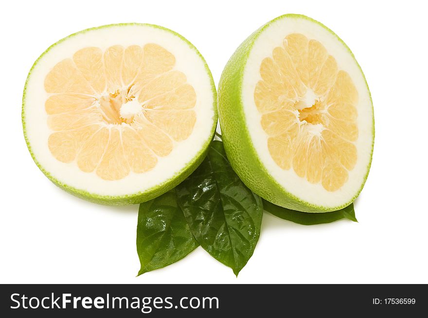 Fresh juicy grapefruits with green leafs isolated over white