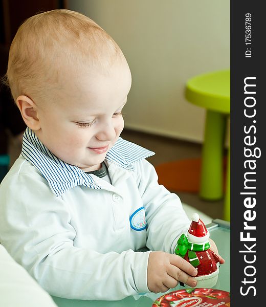 Young child playing with a Santa Claus toy