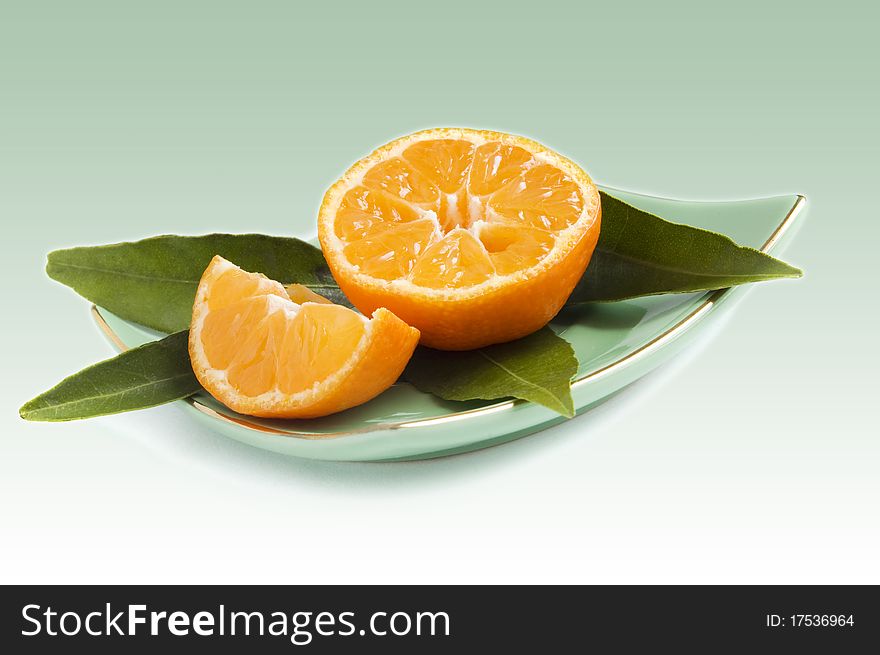 Mandarines fruit with leaves on plate. Mandarines fruit with leaves on plate