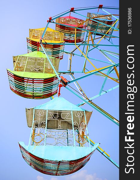 Vivid Colored Ferris Wheel Against The Blue Sky