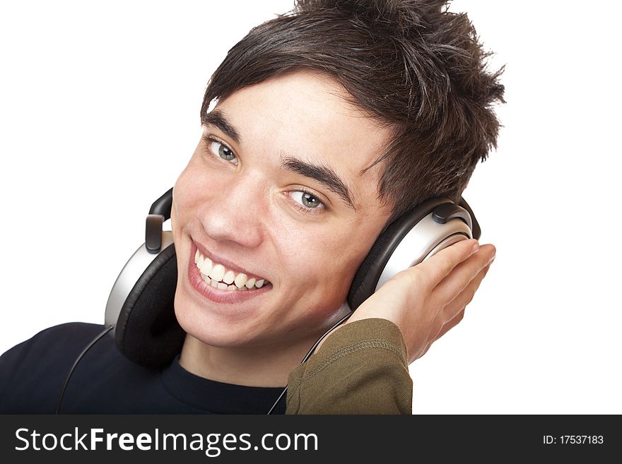 Teenager with headphones listens to music and smiles happy. Isolated on white background. Teenager with headphones listens to music and smiles happy. Isolated on white background.