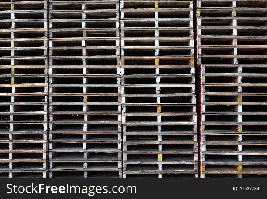 Wooden pallets stacked outside a warehouse