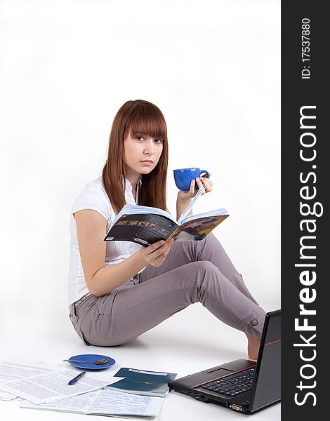 The young girl with the laptop and writing-books. The young girl with the laptop and writing-books