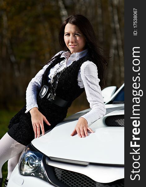 Beautiful girl model and stylish white sports car on nature