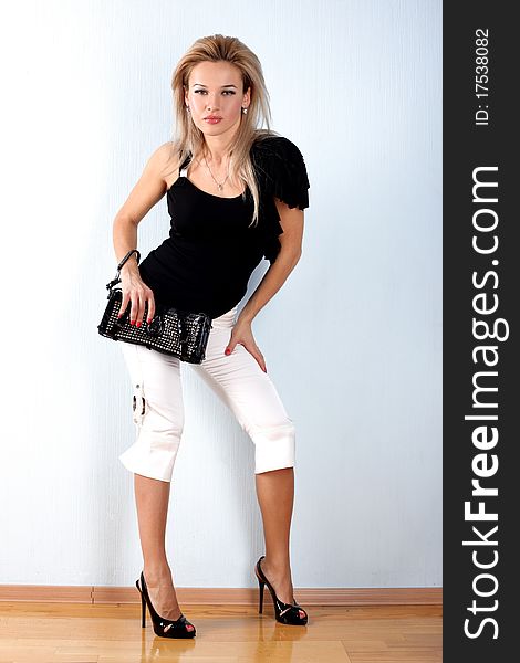 Fashion young woman with clutch bag