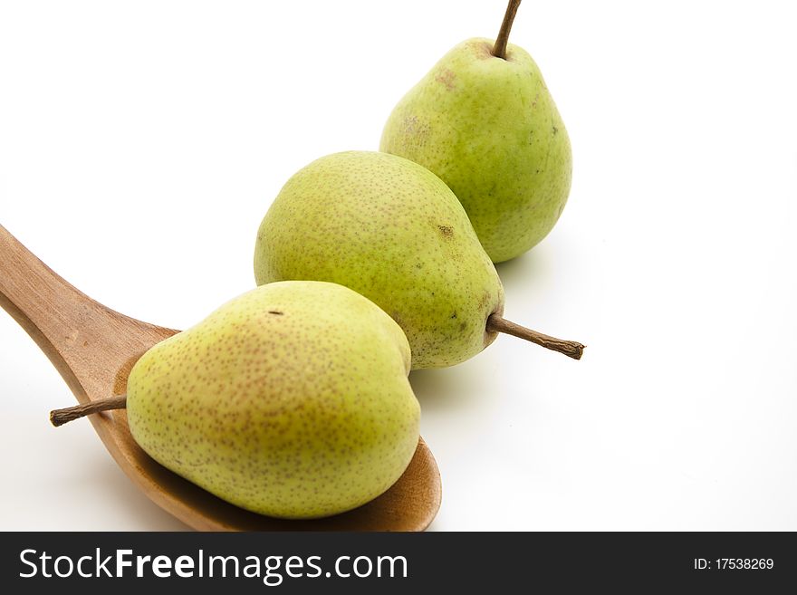 Pear onto wooden spoons onto white background