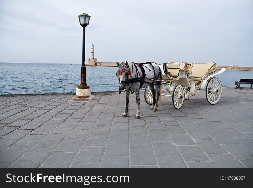 Traditional Horse and Cart on quay of city of island Crete, Greece . Traditional Horse and Cart on quay of city of island Crete, Greece .