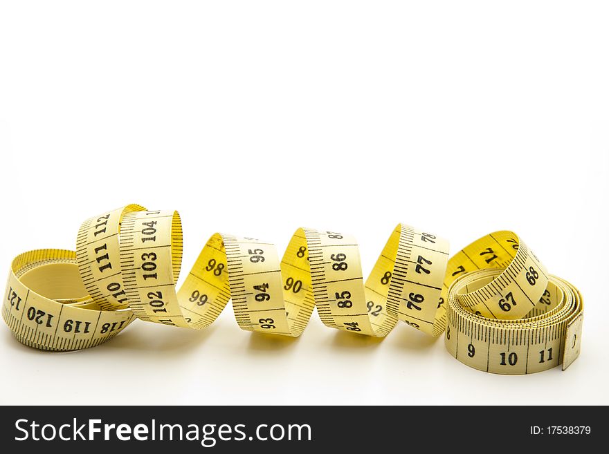 Yellow tape measure onto white background