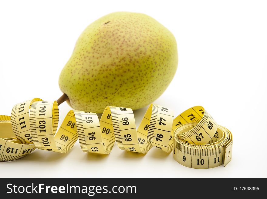 Pear with stem and rolled yellow tape measure. Pear with stem and rolled yellow tape measure