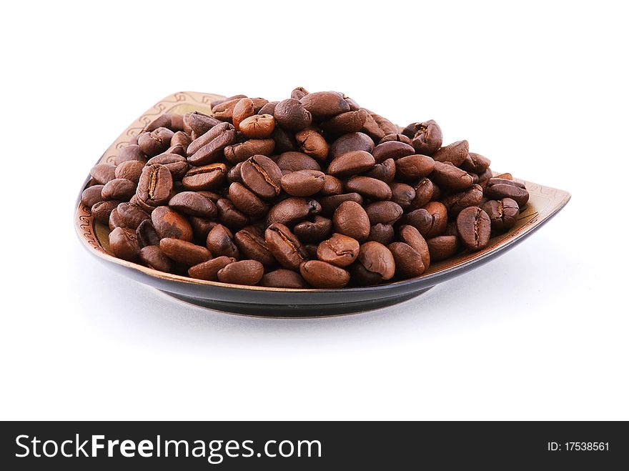 Coffee beans on a plate isolated on white background