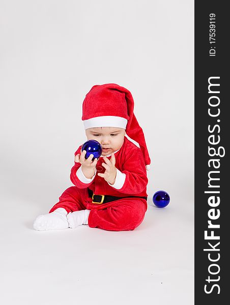 Little boy in Santa clothes playing