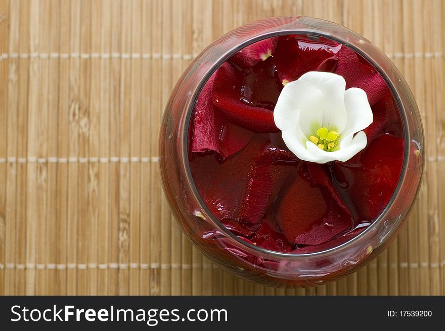 Bowl with petals of red roses