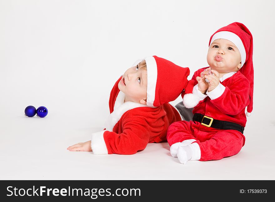 Little boys in Santa clothes playing