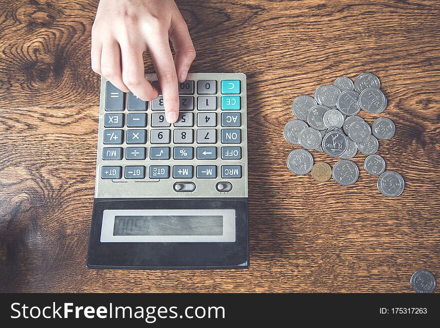 Woman Hand Coins With Calculator