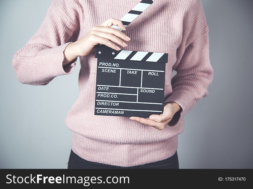 Woman hand movie sign on grey background