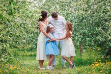 Adorable Family In Blooming Cherry Garden On Beautiful Spring Day Stock Photography