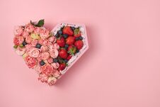 Wooden Box In The Heart Shape Filled With Roses And Ripe Strawberries On A Pink Background Royalty Free Stock Images