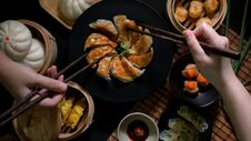 Top View Of Two Female Eating Dim Sum With Gyoza, Dumplings, Salted Egg Pork Balls And Buns Royalty Free Stock Photo