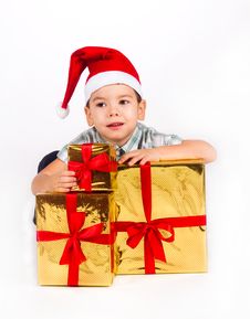 Boy In Santa Hat With A Bunch Of Gifts Royalty Free Stock Photography Boy In Santa Hat With A Bunch Of Gifts Royalty Free Stock Photography