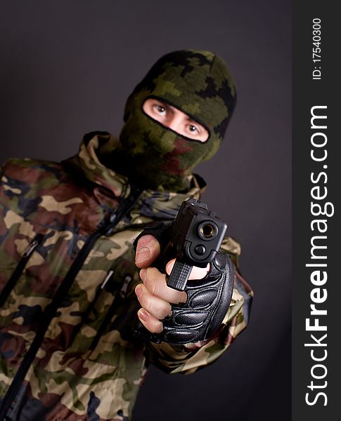 Man in a mask holding gun. Man in a mask holding gun