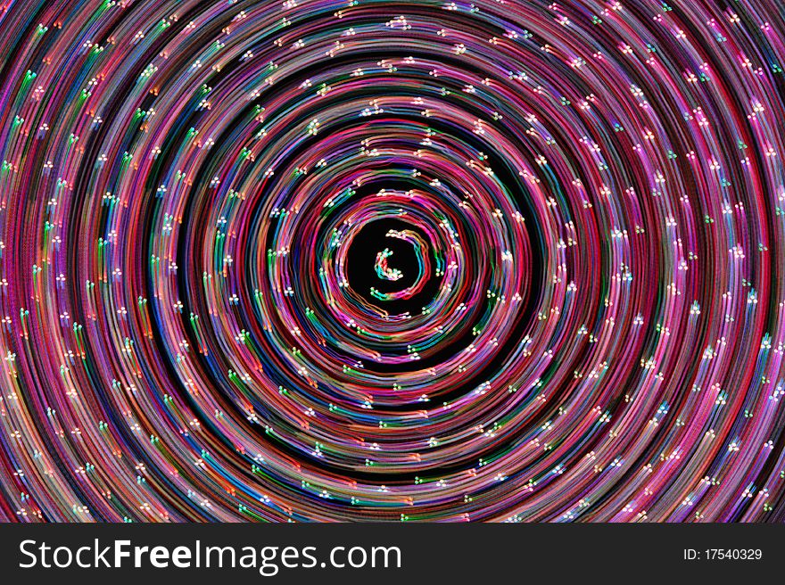 Spinning points of multiple colored lights form abstract image. Spinning points of multiple colored lights form abstract image