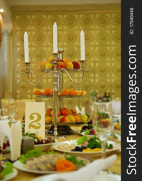 Accent of candlestick and a plate with fruits. Accent of candlestick and a plate with fruits